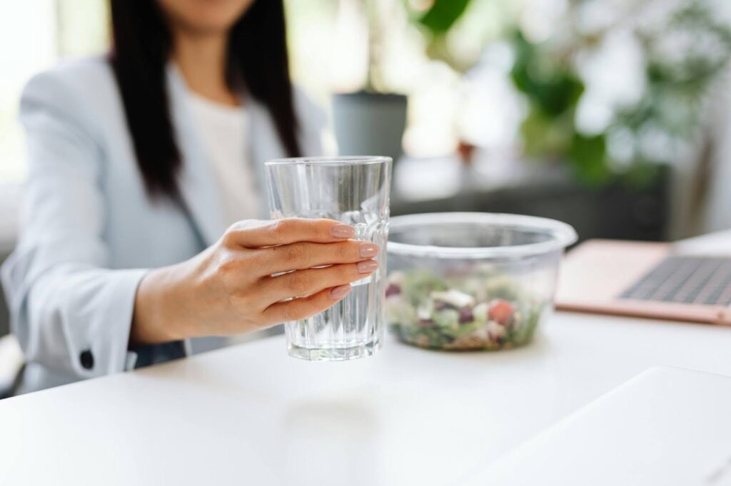 a worker holding a glass of water in an office